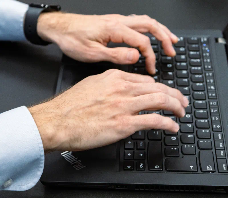 Close up of a person typing on a laptop